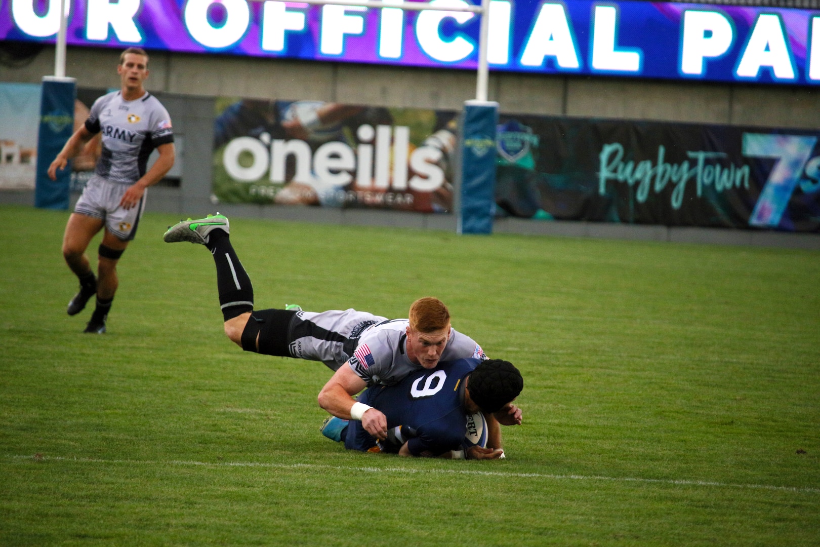 Army Capt. Luke Heun of Fort Benning, Ga. tackles Navy Lt. Adam D'Amico of NPTU Charleston, S.C. during the championship match of the 2022 Armed Forces Sports Men's Rugby Championship held in conjunction with the Rugbytown 7's Rugby Tournament in Glendale, Colo.  Championship features teams from the Army, Marine Corps, Navy, Air Force (with Space Force players), and Coast Guard. (Department of Defense photo by Mr. Steven Dinote).