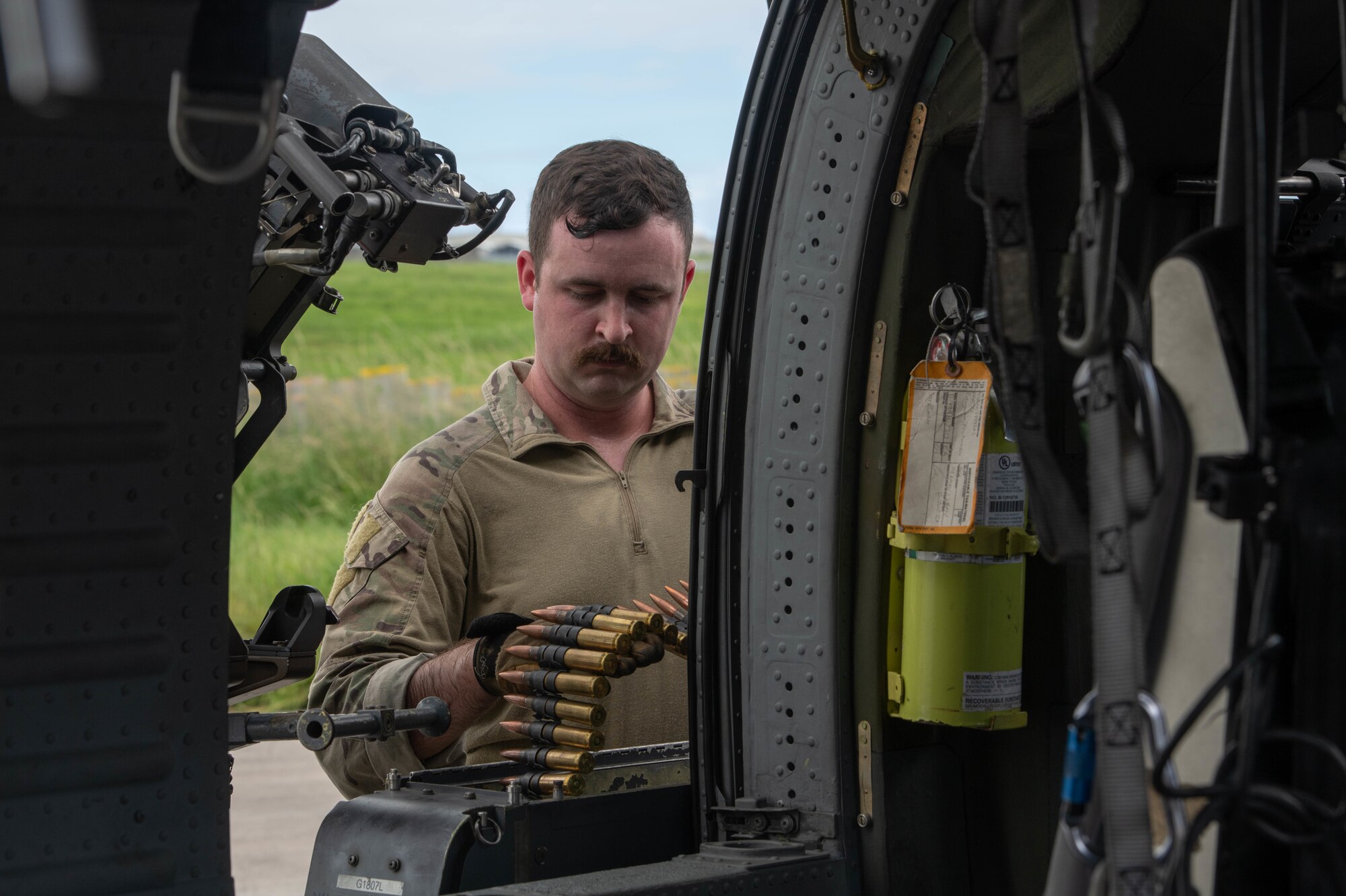 An Airman loads an ammunition box.