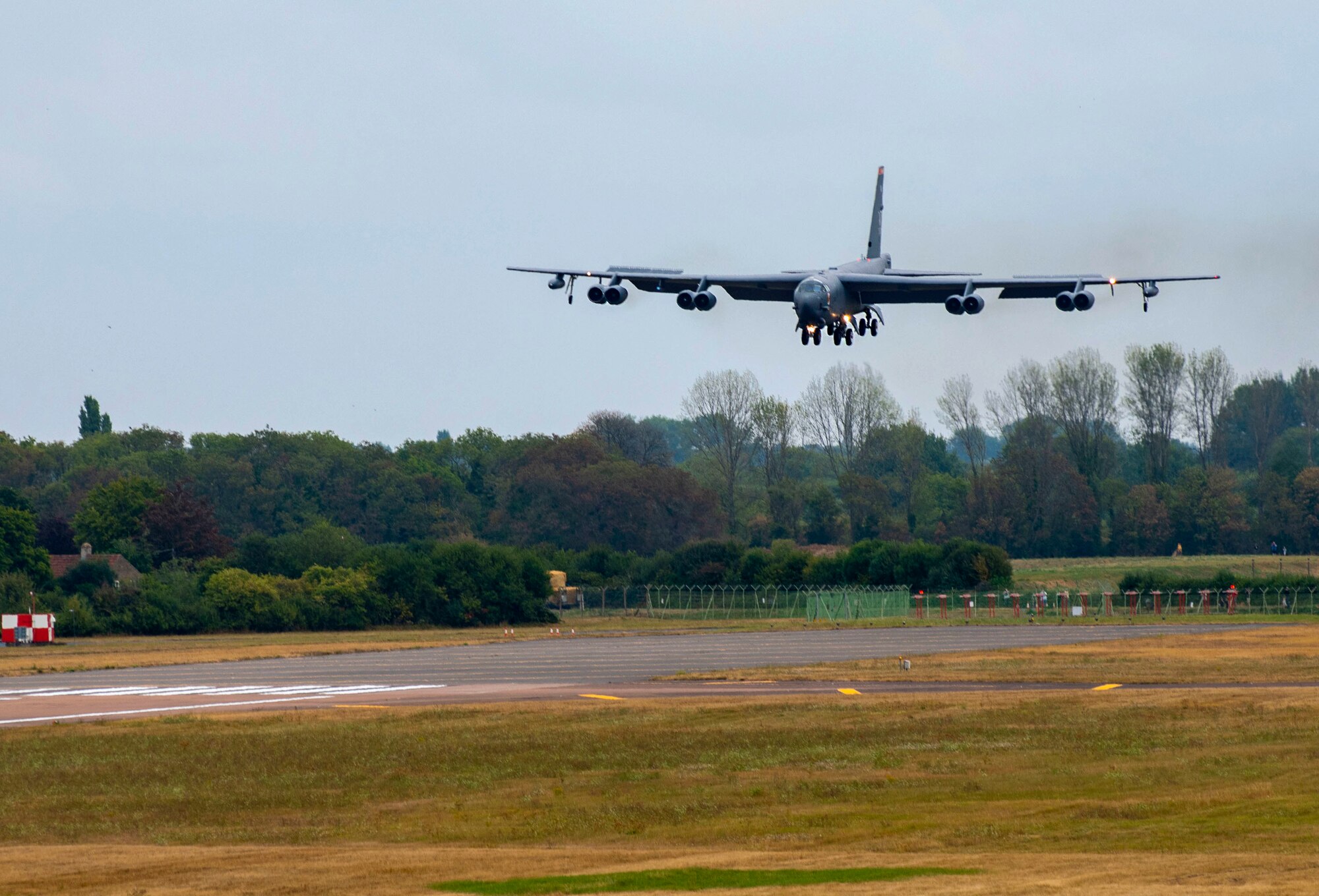 A U.S. Air Force B-52 Stratofortress aircraft, assigned to the 23rd Expeditionary Bomb Squadron, approaches for landing at RAF Fairford