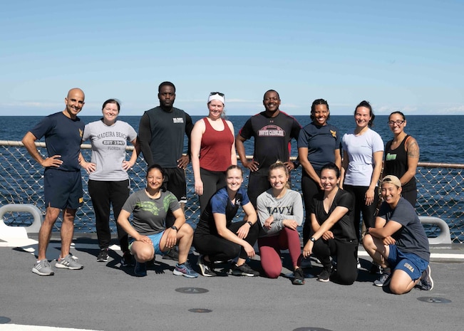 Sailors aboard the Arleigh Burke-class guided-missile destroyer USS Arleigh Burke (DDG 51) participate in a workout commemorating the 50th anniversary of Z-Gram #116, Aug. 7, 2022.