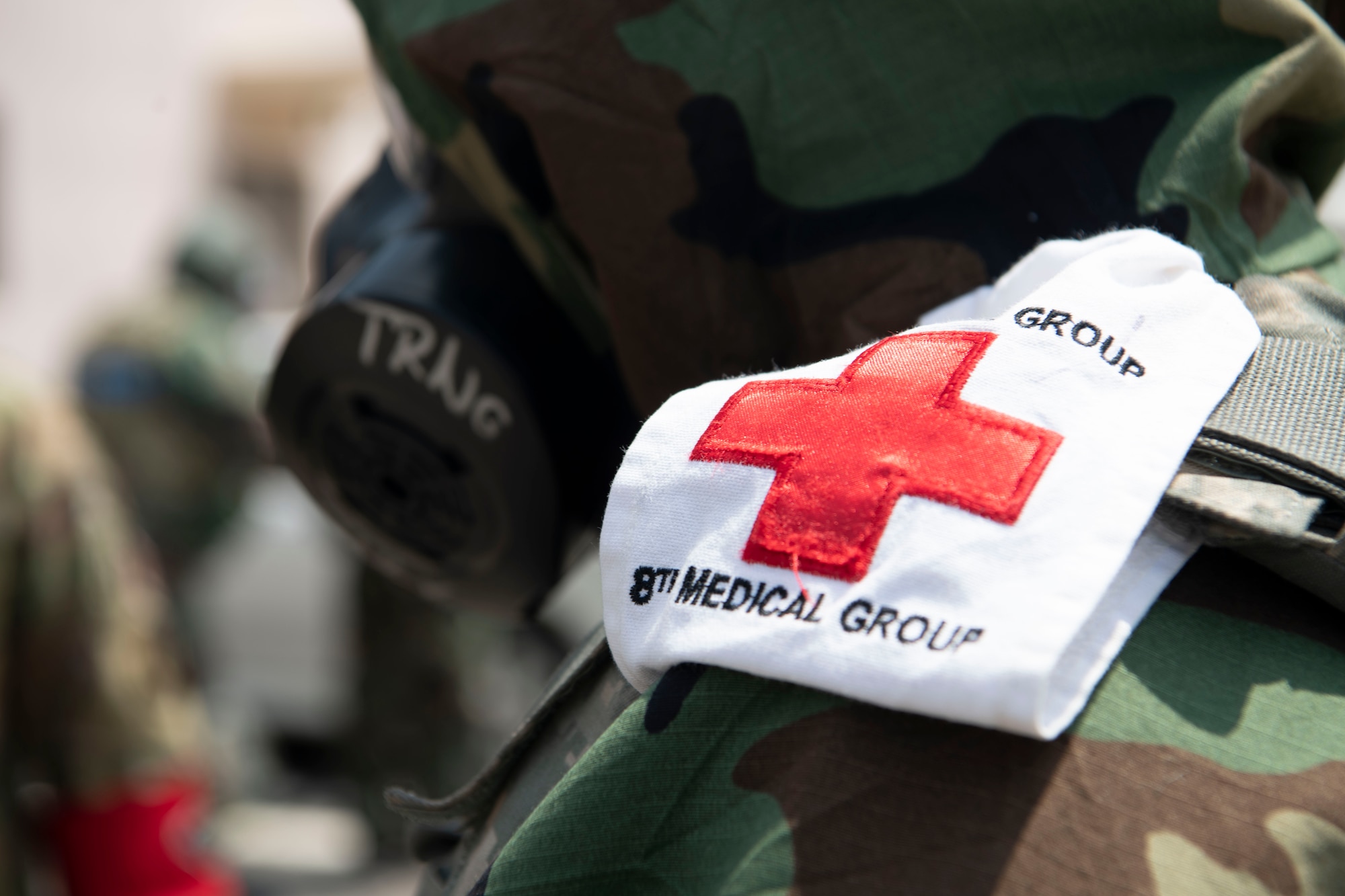 An 8th Medical Group servicemember displays a patch during a training event at Kunsan Air Base, Republic of Korea, Aug. 17, 2022. Training reinforces Airmen readiness, strengthens capabilities and ensures the Wolf Pack has the ability to defend the base, accept follow-on forces and take the fight north. (U.S. Air Force photo by Staff. Sgt Sadie Colbert)