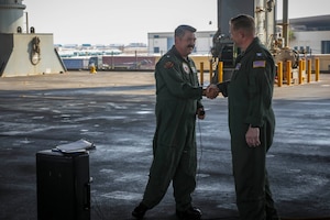 220822-A-EQ028-1104 MANAMA, Bahrain (Aug. 22, 2022) Capt. Richard Burgess, right, outgoing commanding officer for the gold crew of expeditionary sea base USS Lewis B. Puller (ESB 3), shakes hands with Capt. David Skarosi, incoming commanding officer, during a change-of-command ceremony in Manama, Bahrain, Aug. 22. Lewis B. Puller is forward-deployed to the U.S. 5th Fleet area of operations to help ensure maritime security and stability in the Middle East region.