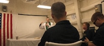 Chaplain Lt. Rene Pellessier, left, embarked aboard Nimitz-class aircraft carrier USS Harry S. Truman (CVN 75), performs a Roman Catholic Mass aboard Arleigh Burke-class guided-missile destroyer USS Forrest Sherman (DDG 98) in the Mediterranean Sea, July 24, 2022.