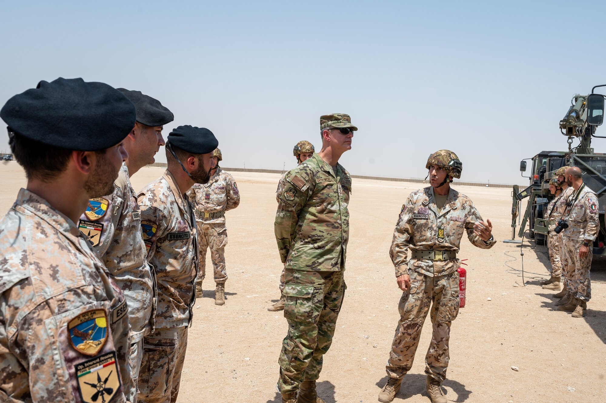 U.S. Air Force Lt. Gen. Alexus G. Grynkewich, center, Ninth Air Force (Air Forces Central) commander, is briefed on a theater-level air defense system by Italian Air Force members at IAF base camp on Ali Al Salem Air Base, Kuwait, Aug. 18, 2022. During the visit, Grynkewich met with Italian military members to discuss the importance of partner nation integration within the U.S. Central Command area of responsibility. (U.S. Air Force photo by Senior Airman Dominic Tyler)