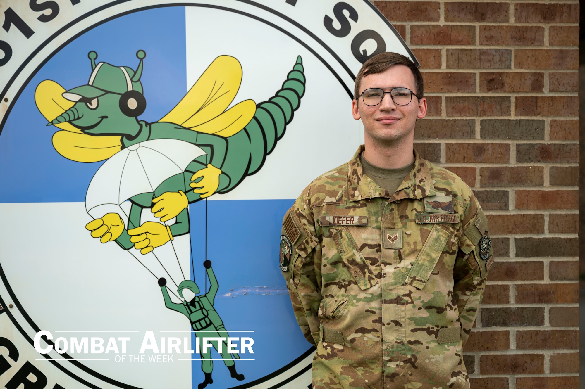 A man in uniform poses for a photo outside