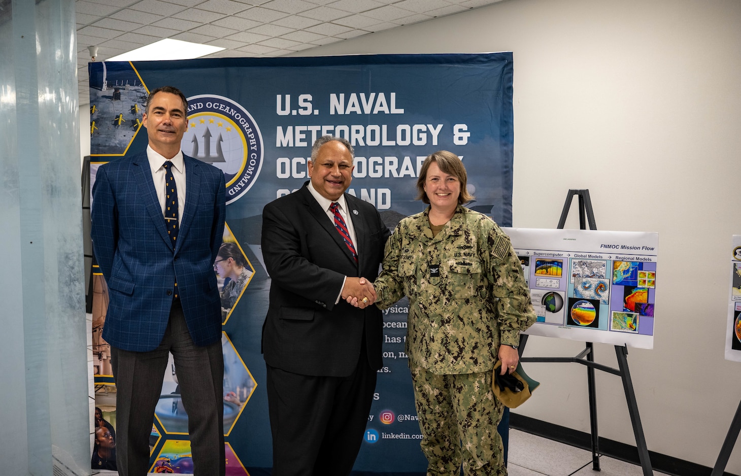 Secretary of the Navy Carlos Del Toro receives a tour of facilities at the Fleet Numerical Meteorology and Oceanography Center (FNMOC) from Capt. Christi Montgomery, commanding officer of FNMOC, in Monterey Aug. 18, 2022.