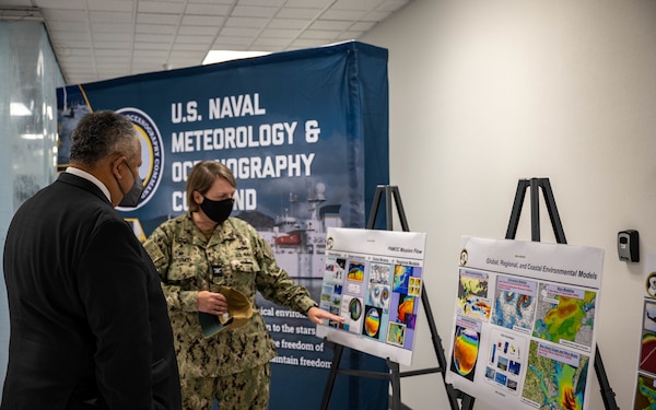 Secretary of the Navy Carlos Del Toro receives a tour of facilities at the Fleet Numerical Meteorology and Oceanography Center (FNMOC) from Capt. Christi Montgomery, commanding officer of FNMOC, in Monterey Aug. 18, 2022.