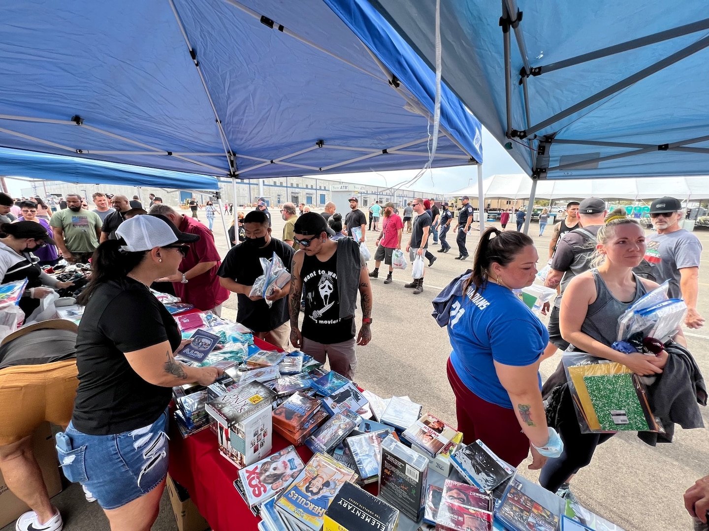 DDJC Civilian Welfare Fund volunteers hand out goods provided by Operation Care and Comfort to DDJC employees during an Employee Appreciation Day at the DDJC installation on Aug 17, 2022.