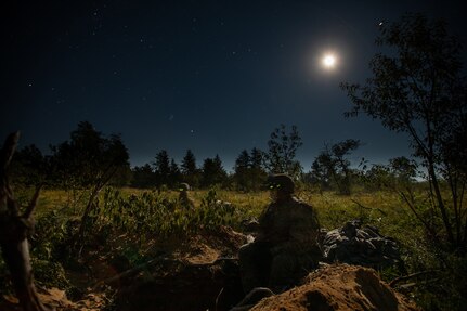 Infantry Soldiers assigned to 1st Battalion, 148th Infantry Regiment man their foxholes before force-on-force operations during Operation Northern Strike at Camp Grayling, Mich., Aug. 15, 2022.