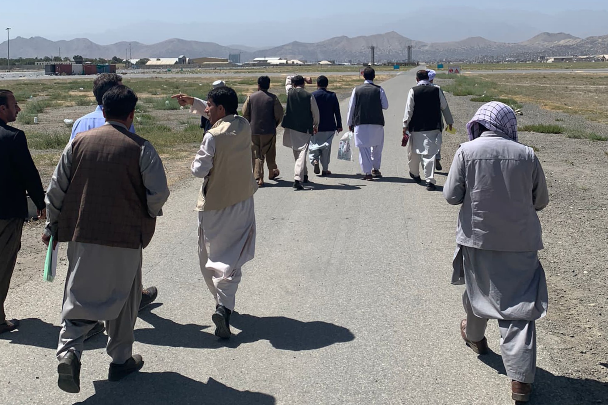 Captain Adam Solomon, 332nd Expeditionary Operations Support Squadron airfield operations flight commander, escorts senior Taliban members to the air traffic control tower August, 2021, at Hamid Karzai International Airport (HKIA), Afghanistan.