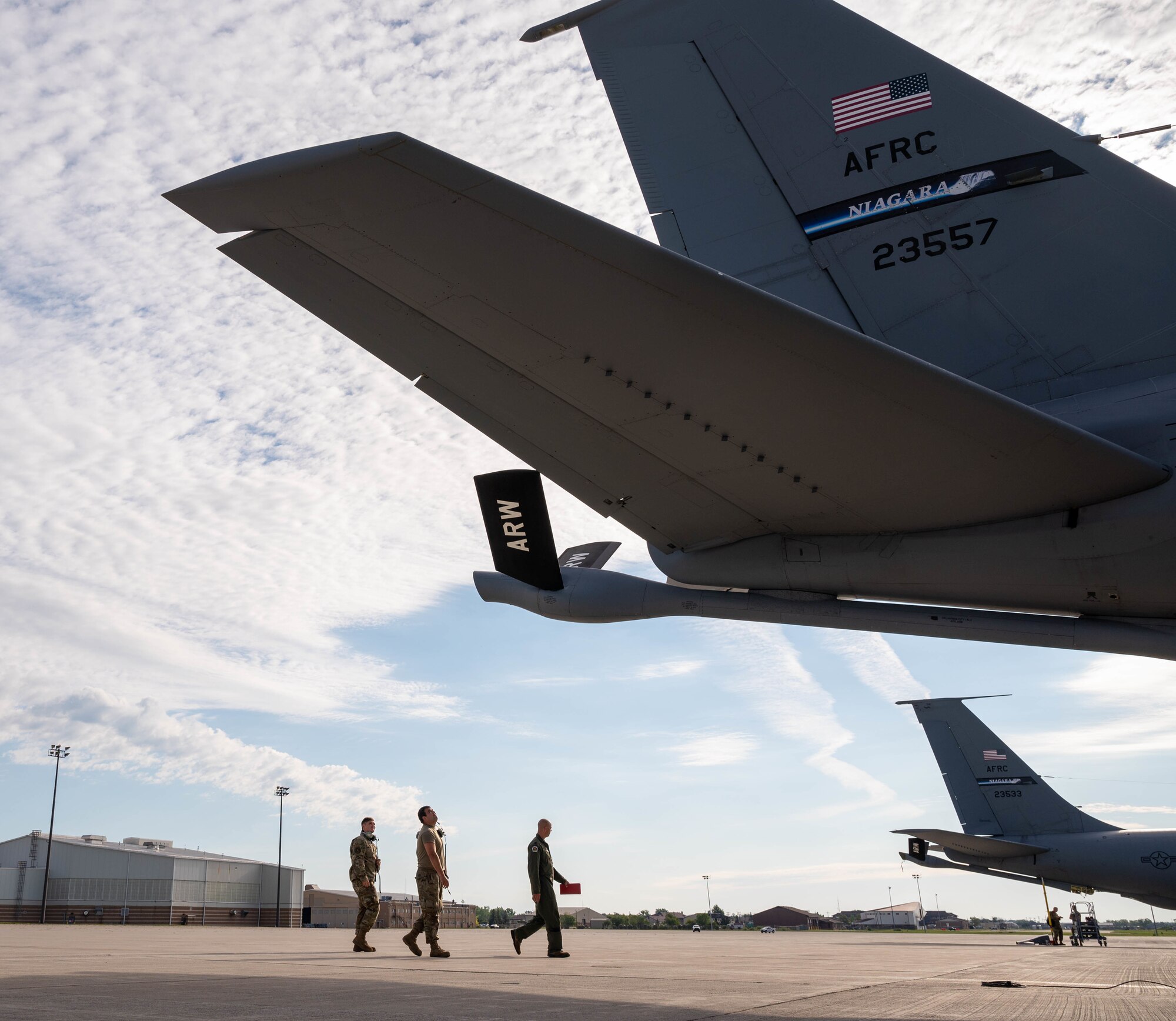 Pilots and crew chiefs with the 914th Air Refueling Wing walk around the tail of a KC-135 Stratotanker during a preflight inspection