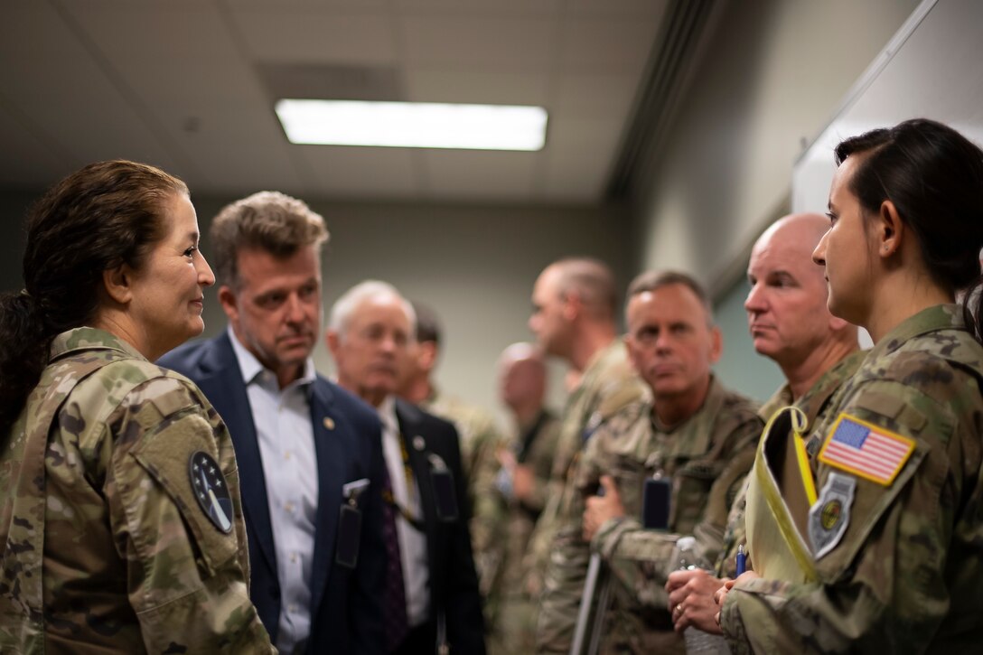 U.S. Space Force Capt. Rachel Alessi (right), SPACE FLAG 22-3 tactical assistant, brief SPACE FLAG distinguished visitors on her role guiding exercise players through the mission planning and execution process