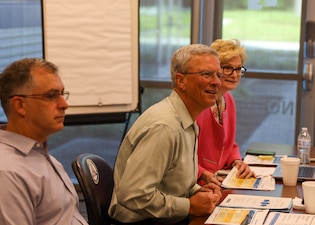 PENSACOLA, Fla. (Aug. 17, 2022) Kent Miller, executive director for Naval Education and Training Command (NETC), center, speaks with NETC headquarters leaders during the NETC Force Development fiscal year 2023 strategic offsite Aug. 17, 2022. Senior members of the staff came together to discuss NETC’s mission and vision statements and refine strategic goals and objectives and annual goals. (U.S. Navy photo by Wade Buffington)