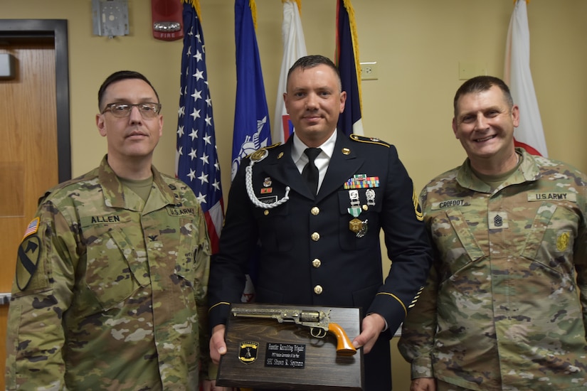 Dress uniformed Soldier accepts award