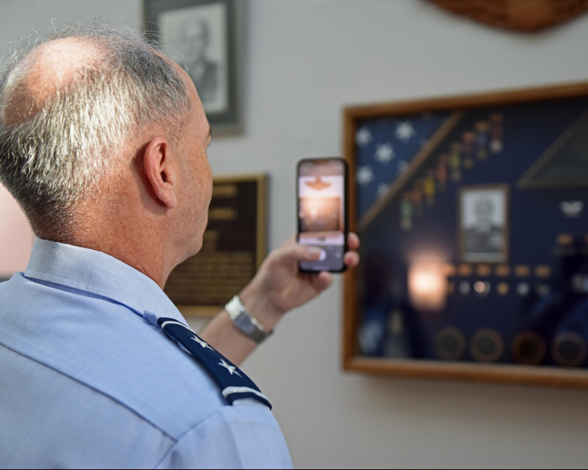 U.S. Air Force Maj. Gen. Michael Downs, Joint Staff deputy director for intelligence, surveillance and reconnaissance operations; and director, Joint Intelligence, Surveillance and Reconnaissance Operations Center; takes a photo of the Charles Powell dedication at the Powell Event Center, Goodfellow Air Force Base, Texas, Aug. 17, 2022. The event center was renamed the Powell Event Center to honor U.S. Air Force retired Col. Charles E. Powell, a previous commander of the 3480th Technical Training Wing at Goodfellow, on Sept. 10, 2021. (U.S. Air Force photo by Airman 1st Class Sarah Williams)