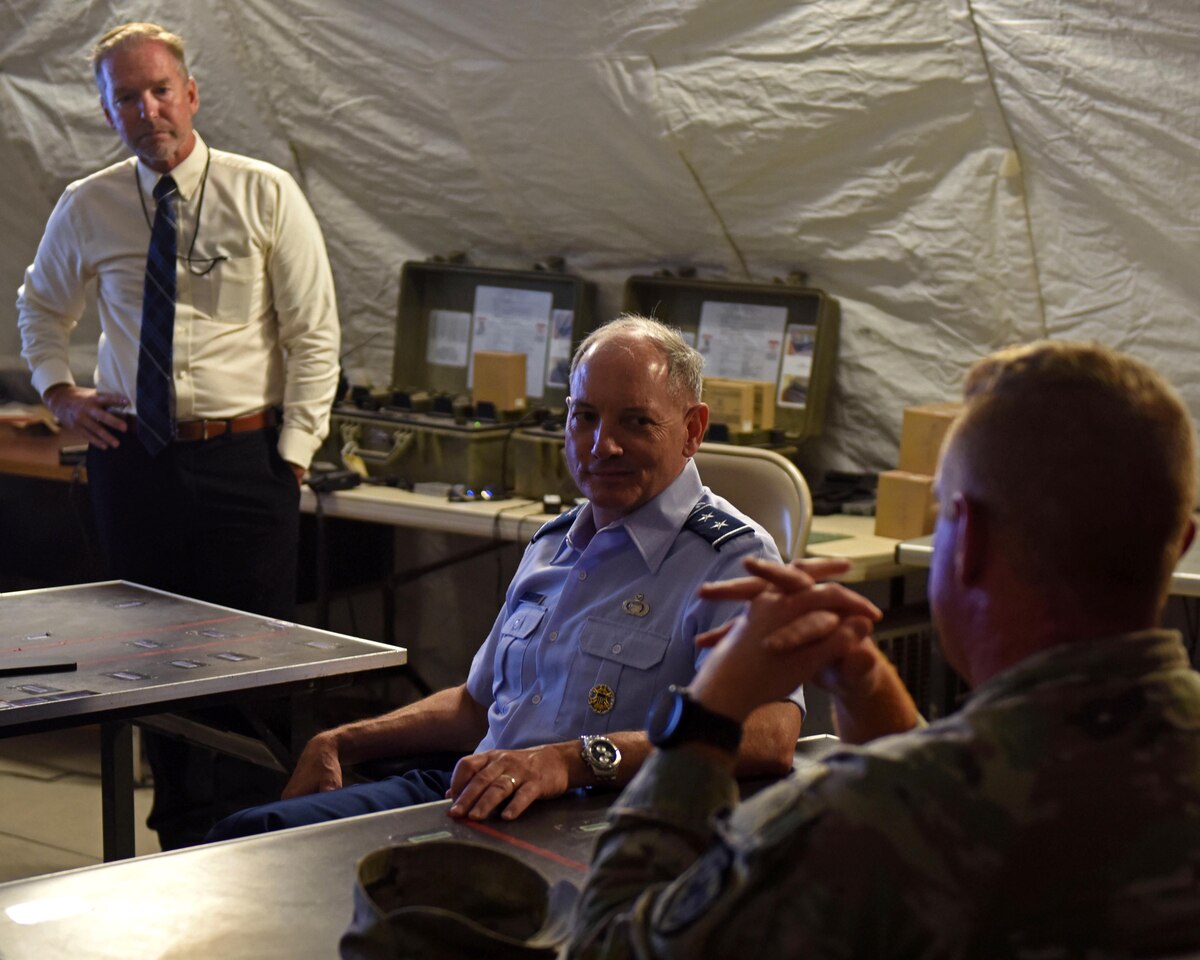 U.S. Air Force Maj. Gen. Michael Downs, Joint Staff deputy director for intelligence, surveillance and reconnaissance operations; and director, Joint Intelligence, Surveillance and Reconnaissance Operations Center; meets with a member of the 344th Military Intelligence Battalion at Forward Operating Base Sentinel, Goodfellow Air Force Base, Texas, Aug. 17, 2022. FOB Sentinel serves as the 344th Military Intelligence Battalion’s capstone exercise where students apply their skills learned throughout their training in a simulated combat environment. (U.S. Air Force photo by Airman 1st Class Sarah Williams)