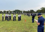 Chief Petty Officer George Soto calculates points for the Female Armed Platoon drill competition at Monarch High School, Coconut Creek, Florida, Jan. 22. Soto is the Coast Guard recipient of the 2022 League of United Latin American Citizens (LULAC) Excellence in Service Award. (USCG Courtesy Photo)