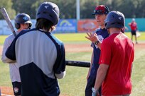 Alaska National Guard State Command Chaplain (Col.) Ted McGovern coaches baseball players during warm-up exercises before a baseball game at the Mulcahy Stadium in Anchorage, Alaska, July 23, 2022. In addition to serving the Alaska Guard family, McGovern serves the communities surrounding Joint Base Elmendorf-Richardson as an assistant coach for the Chugiak-Eagle River Chinooks, a local collegiate baseball team in Chugiak. (Alaska National Guard photo by 1st Lt. Balinda O’Neal)