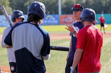 Alaska National Guard State Command Chaplain (Col.) Ted McGovern coaches baseball players during warm-up exercises before a baseball game at the Mulcahy Stadium in Anchorage, Alaska, July 23, 2022. In addition to serving the Alaska Guard family, McGovern serves the communities surrounding Joint Base Elmendorf-Richardson as an assistant coach for the Chugiak-Eagle River Chinooks, a local collegiate baseball team in Chugiak. (Alaska National Guard photo by 1st Lt. Balinda O’Neal)