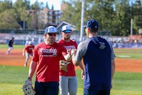 Alaska National Guard State Command Chaplain (Col.) Ted McGovern coaches baseball players during warm-up exercises before a baseball game at the Mulcahy Stadium in Anchorage, Alaska, July 23, 2022. In addition to serving the Alaska Guard family, McGovern serves the communities surrounding Joint Base Elmendorf-Richardson as an assistant coach for the Chugiak-Eagle River Chinooks, a local collegiate baseball team in Chugiak. (Alaska National Guard photo by 1st Lt. Balinda O’Neal)