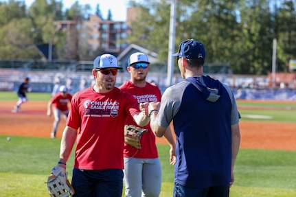 Alaska National Guard State Command Chaplain (Col.) Ted McGovern coaches baseball players during warm-up exercises before a baseball game at the Mulcahy Stadium in Anchorage, Alaska, July 23, 2022. In addition to serving the Alaska Guard family, McGovern serves the communities surrounding Joint Base Elmendorf-Richardson as an assistant coach for the Chugiak-Eagle River Chinooks, a local collegiate baseball team in Chugiak. (Alaska National Guard photo by 1st Lt. Balinda O’Neal)