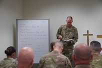 Alaska National Guard State Command Chaplain (Col.) Ted McGovern reads scripture from Luke 12:35-40 during a Chapel Service for Alaska Guardsmen serving during drill weekend at the AKNG Armory on Joint Base Elmendorf-Richardson, Aug. 7, 2022. The service, focusing on watchfulness, paralleled the importance of readiness in the Guard. (Alaska National Guard photo by Mr. Dana Rosso)