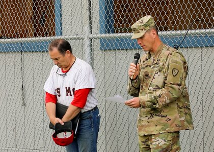 Alaska National Guard State Command Chaplain (Col.) Ted McGovern, right, delivers the opening prayer as Tim Barto, the Chugiak-Eagle River Chinooks Booster Club president, bows his head in unison during a military appreciation baseball game in Chugiak, Alaska, July 14, 2022. In addition to serving the Alaska Guard family, McGovern serves the communities surrounding Joint Base Elmendorf-Richardson as an assistant coach for a local collegiate baseball team. (Alaska National Guard photo by 1st Lt. Balinda O’Neal)
