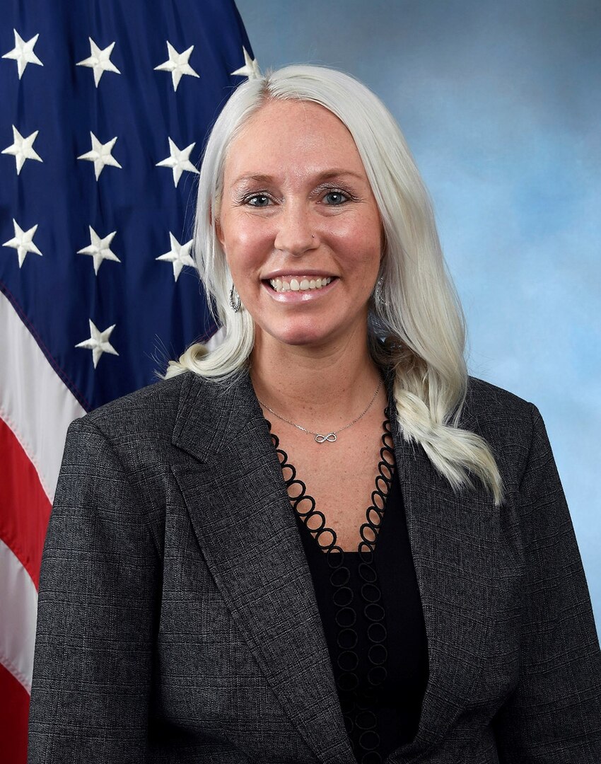 Portrait of woman with American flag in the background.