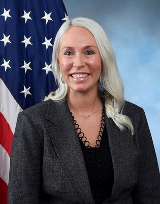 Portrait of woman with American flag in the background.