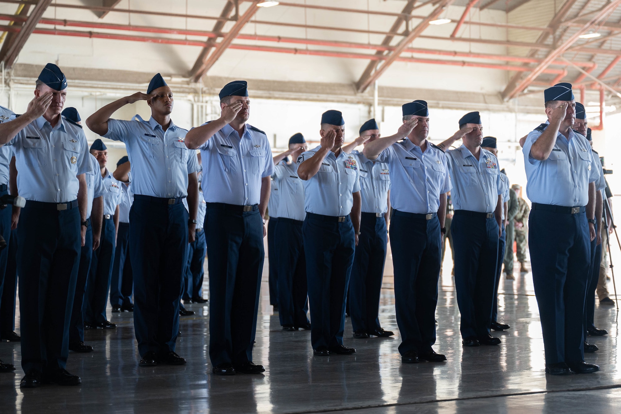 U.S. Air Force members from the 19th Air Force, salute during the 19th Air Force change of command ceremony August 19, 2022, at Joint Base San Antonio-Randolph, Texas. 19th Air Force is responsible for 32,000 Total Force personnel and 1,530 aircraft assigned to 17 Total Force wings located across the U.S. (U.S. Air Force photo by Senior Airman Tyler McQuiston)