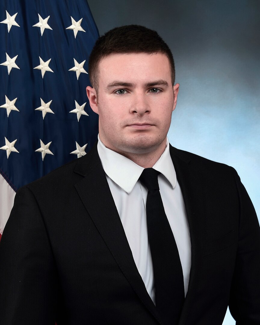 Portrait of male with American flag in the background.