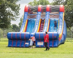 Army children play on slide at an organizational day