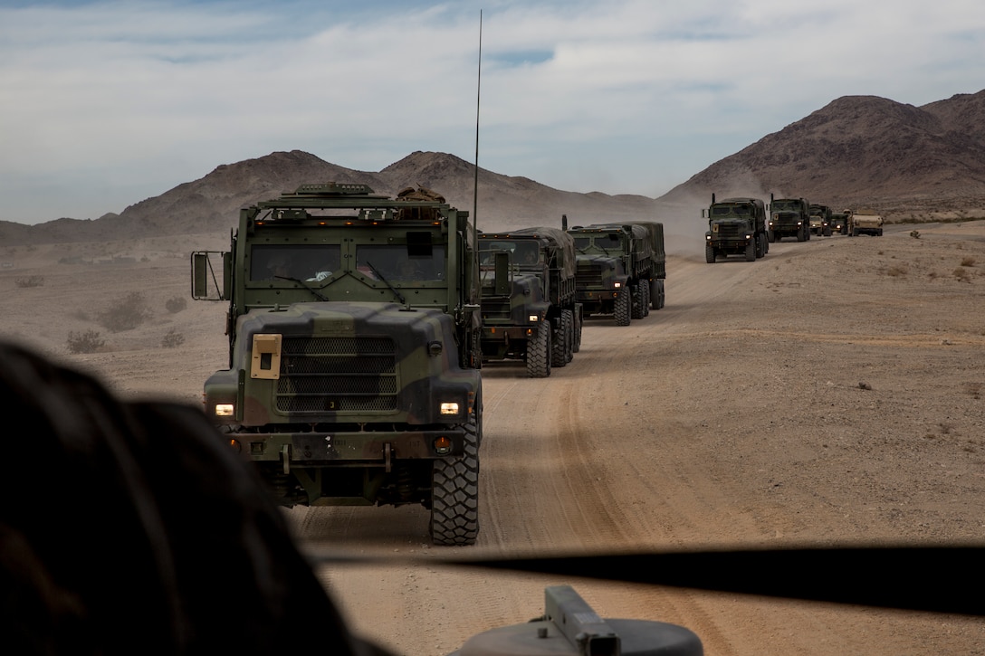 U.S. Marines with 3rd Battalion, 7th Marine Regiment, 1st Marine Division, are transported by MTVR 7-ton trucks during a Marine Corps Combat Readiness Evaluation at Marine Corps Air Ground Combat Center, Twentynine Palms, Calif., Nov. 27, 2017. Marine Corps Systems Command is collaborating with the Defense Innovation Unit and Marine Corps Combat Development & Integration command to bring cutting-edge electrical vehicle technology to the Corps’ medium and heavy tactical vehicles.  (U.S. Marine Corps photo by Cpl. Joseph Prado)