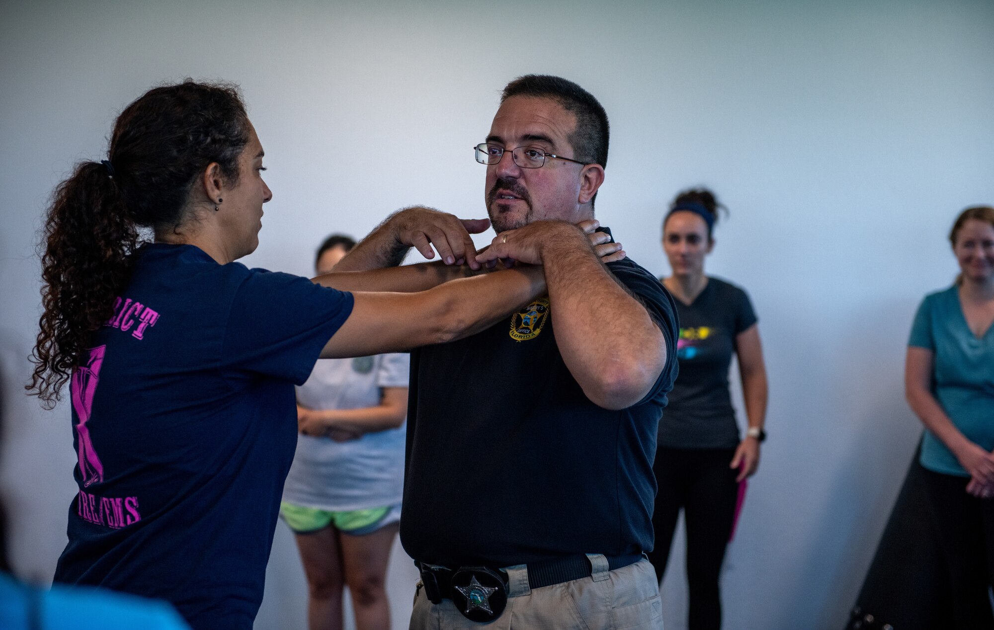 Instructor demonstrates how to break a choke hold