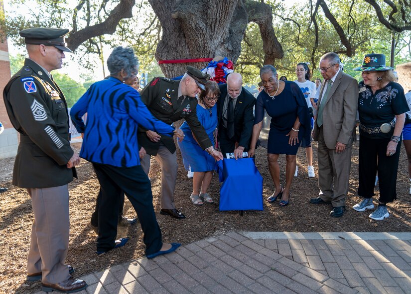 U.S. Army Lt. Gen. John Evans, commanding general of U.S. Army North, Command Sgt. Phil Barreto, senior enlisted advisor for U.S. Army North, Nan Burley Richie, Roy W. Burley, Jr., Dr. Adena Loston, president of St. Philip’s College and other community members reveal the dedication plaque during the St. Philip’s College Col. Burley Oak Tree Dedication Ceremony, held on the St. Philip’s College’s campus, August 18, 2022. The 100-plus-year-old oak tree is part of the Burley homestead of the late retired U.S. Army Col. Roy W. Burley, Sr., for many generations. The tree now resides on the college campus with a plaque to share with future generations the legacy of “The Colonel”. (U.S. Army Photo by Bethany L. Huff)