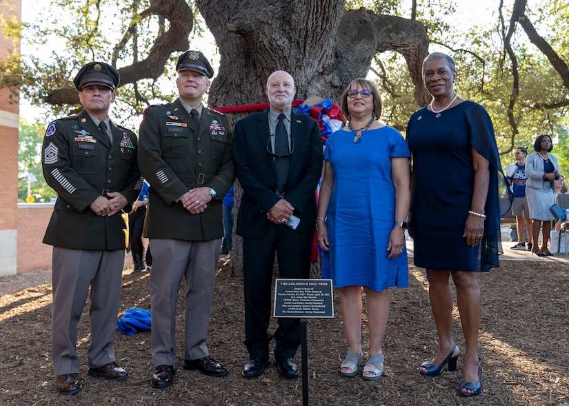 (From left to right) Command Sgt. Maj. Phil Barretto, Lt. Gen. John Evans, Roy W. Burley, Jr., Nan Burley Richie, and Dr. Adena Loston, stand with the dedication plaque and oak tree during the St. Philip’s College Col. Burley Oak Tree Dedication Ceremony, held on the St. Philip’s College’s campus, August 18, 2022. The 100-plus-year-old oak tree is part of the Burley homestead of the late retired U.S. Army Col. Roy W. Burley, Sr., for many generations. The tree now resides on the college campus with a plaque to share with future generations the legacy of “The Colonel”. (U.S. Army Photo by Bethany L. Huff)