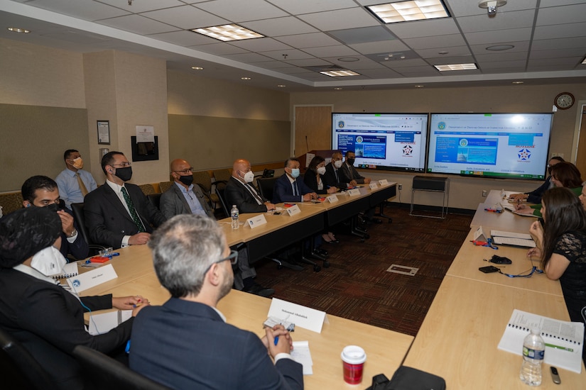 People sit around a conference table.