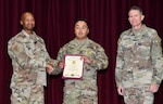 Major Gen. Michael Talley, Commanding General, U.S. Army Medical Center of Excellence, presents Sgt. First Class Troy Mata with the Army Master Instructor Badge during a MEDCoE quarterly awards ceremony August 10.