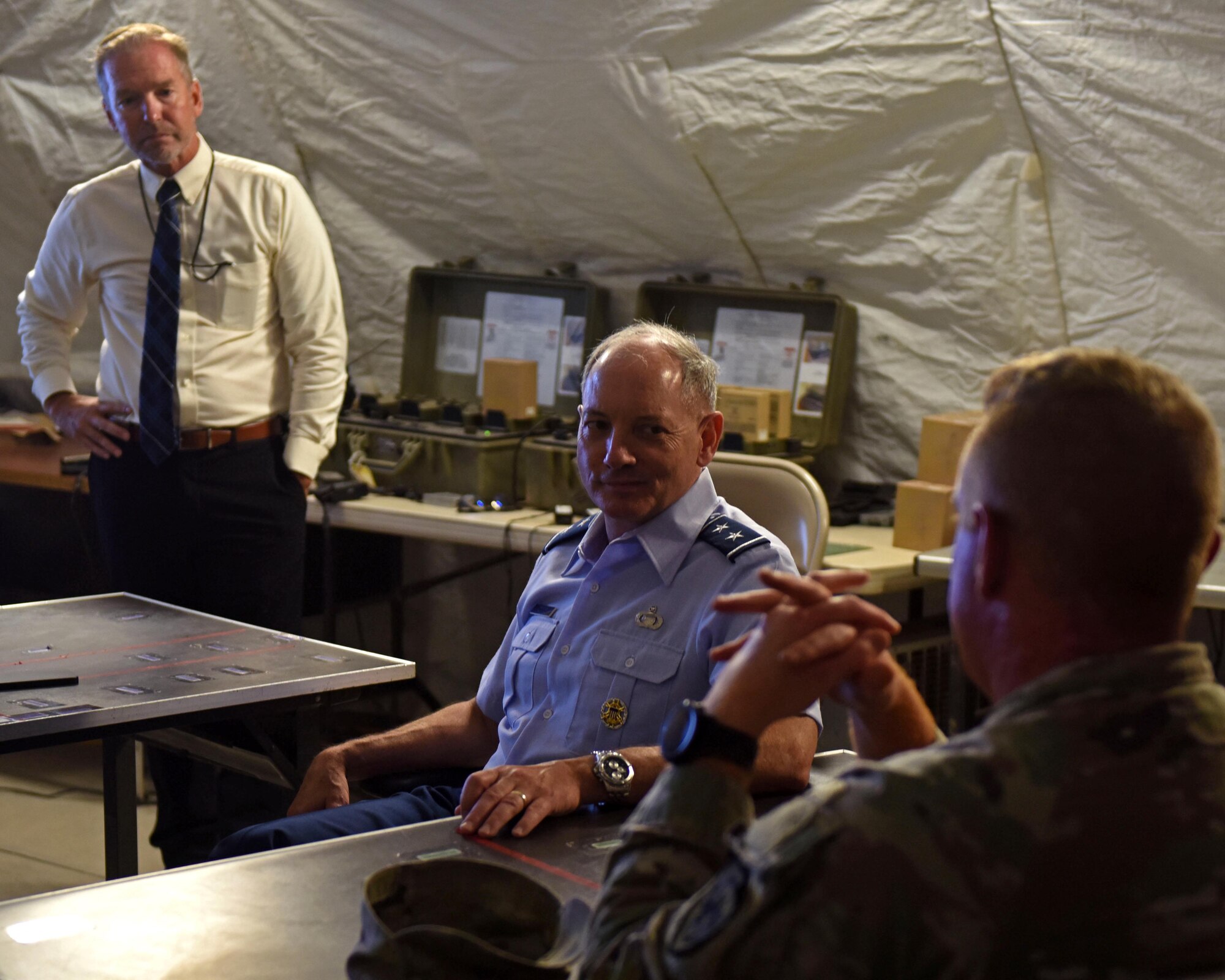 U.S. Air Force Maj. Gen. Michael Downs, Joint Staff deputy director for intelligence, surveillance and reconnaissance operations; and director, Joint Intelligence, Surveillance and Reconnaissance Operations Center; meets with a member of the 344th Military Intelligence Battalion at Forward Operating Base Sentinel, Goodfellow Air Force Base, Texas, Aug. 17, 2022. FOB Sentinel serves as the 344th Military Intelligence Battalion’s capstone exercise where students apply their skills learned throughout their training in a simulated combat environment. (U.S. Air Force photo by Airman 1st Class Sarah Williams)