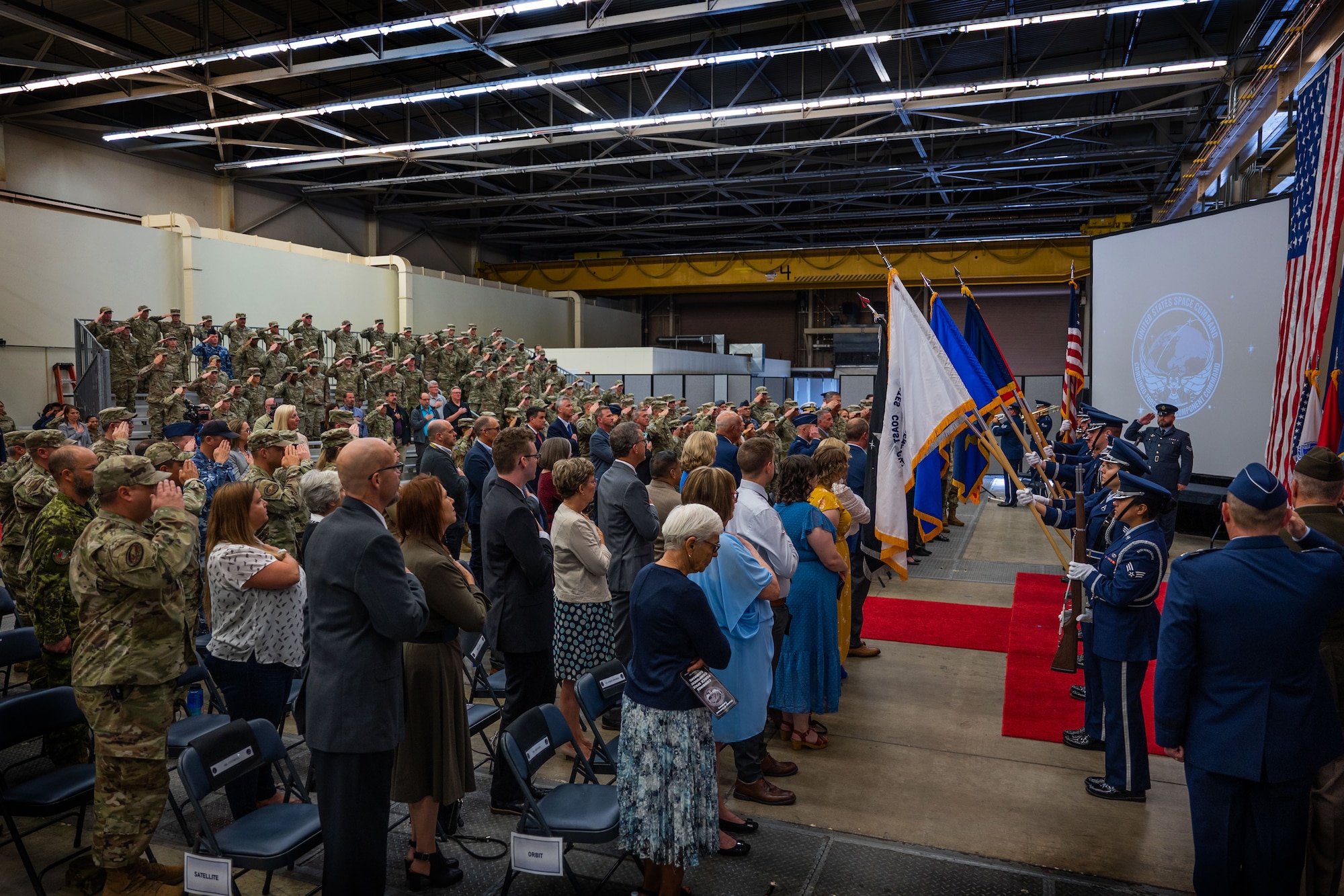 Attendees of the Combined Force Space Component Command (CFSCC) change of command ceremony stand during the National Anthem at Vandenberg Space Force Base, Calif., Aug. 22, 2022. More than 350 people attended the event, both in-person and virtually, to welcome incoming CFSCC commander, Maj. Gen. Douglas A. Schiess, and also say farewell to the outgoing CFSCC commander Maj. Gen. DeAnna M. Burt, after she served as the unit’s commander for 21 months. (U.S. Space Force photo by Tech. Sgt. Luke Kitterman)