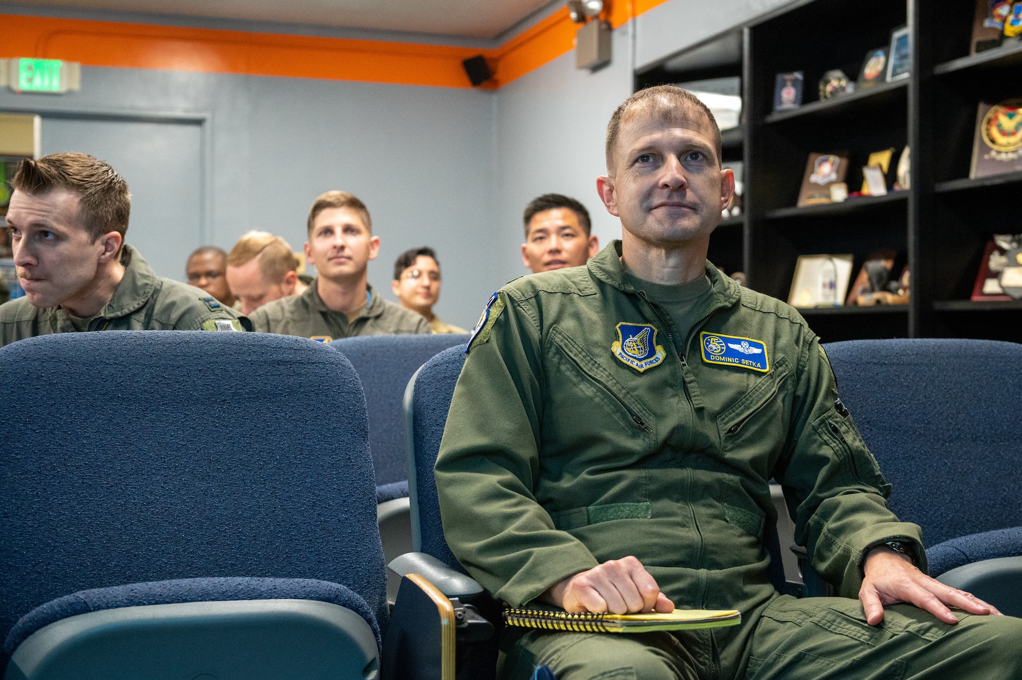 Men listen to a mission brief