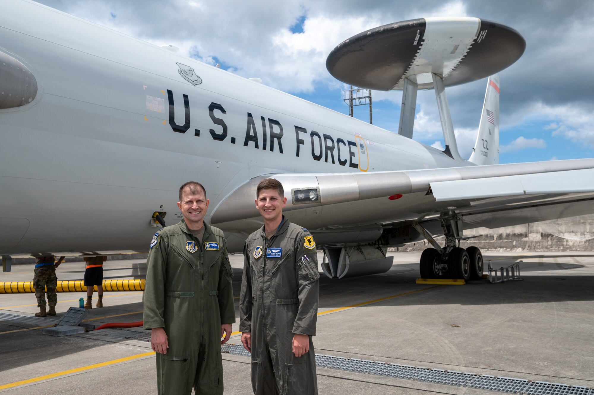 Father and son stand in front of an aircraft