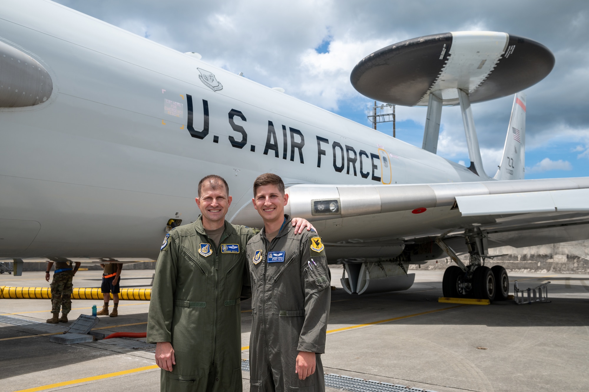 Father and son stand in front of an aircraft
