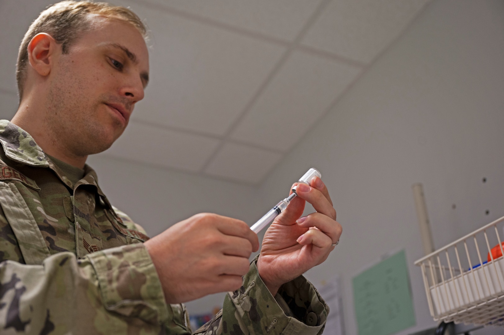 U.S. Air Force Staff Sgt. Joseph Holweger, 86th Medical Group non-commissioned officer in charge of the Immunizations Clinic, prepares a vaccine at Ramstein Air Base Germany, Aug. 18, 2022. Holweger and the rest of his team at the immunizations Clinic on base are prepared to issue the Novavax vaccine to those interested. (U.S. Air Force photo by Senior Airman Thomas Karol)