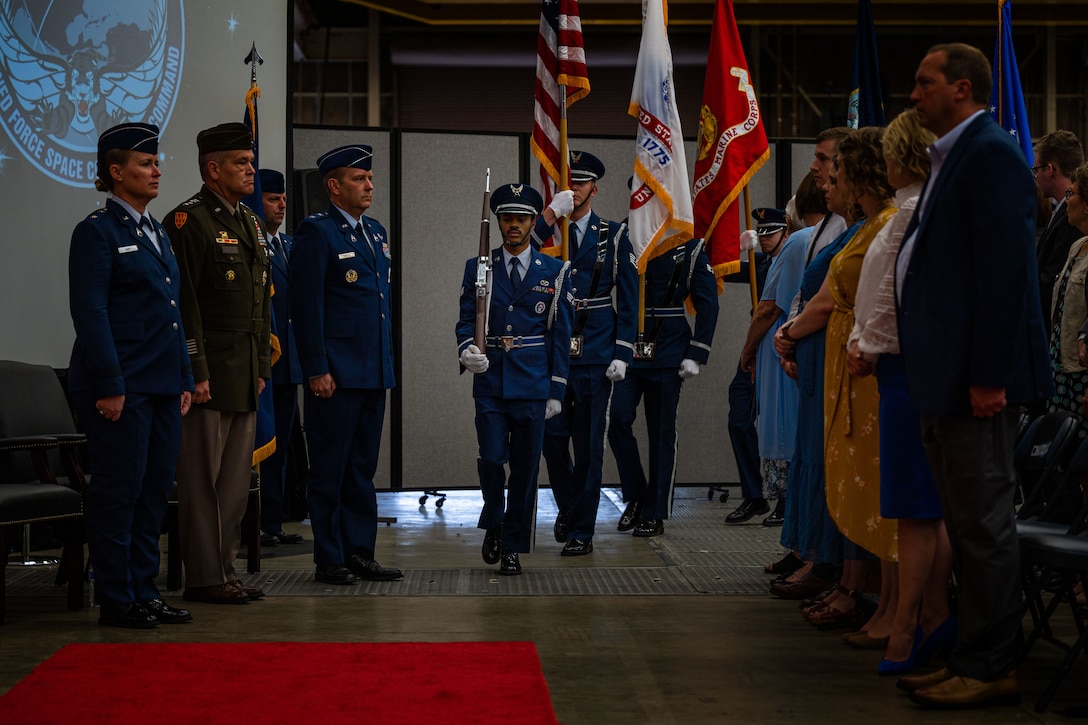 Members of the base Honor Guard team march past audience members and the official party for the Combined Force Space Component Command (CFSCC) change of command ceremony at Vandenberg Space Force Base, Calif., Aug. 22, 2022. U.S. Army Gen. James H. Dickinson, U.S. Space Command commander, was the presiding officer for the ceremony and transferred CFSCC’s command from U.S. Space Force Maj. Gen. DeAnna M. Burt to U.S. Space Force Maj. Gen. Douglas A. Schiess. (U.S. Space Force photo by Tech. Sgt. Luke Kitterman)