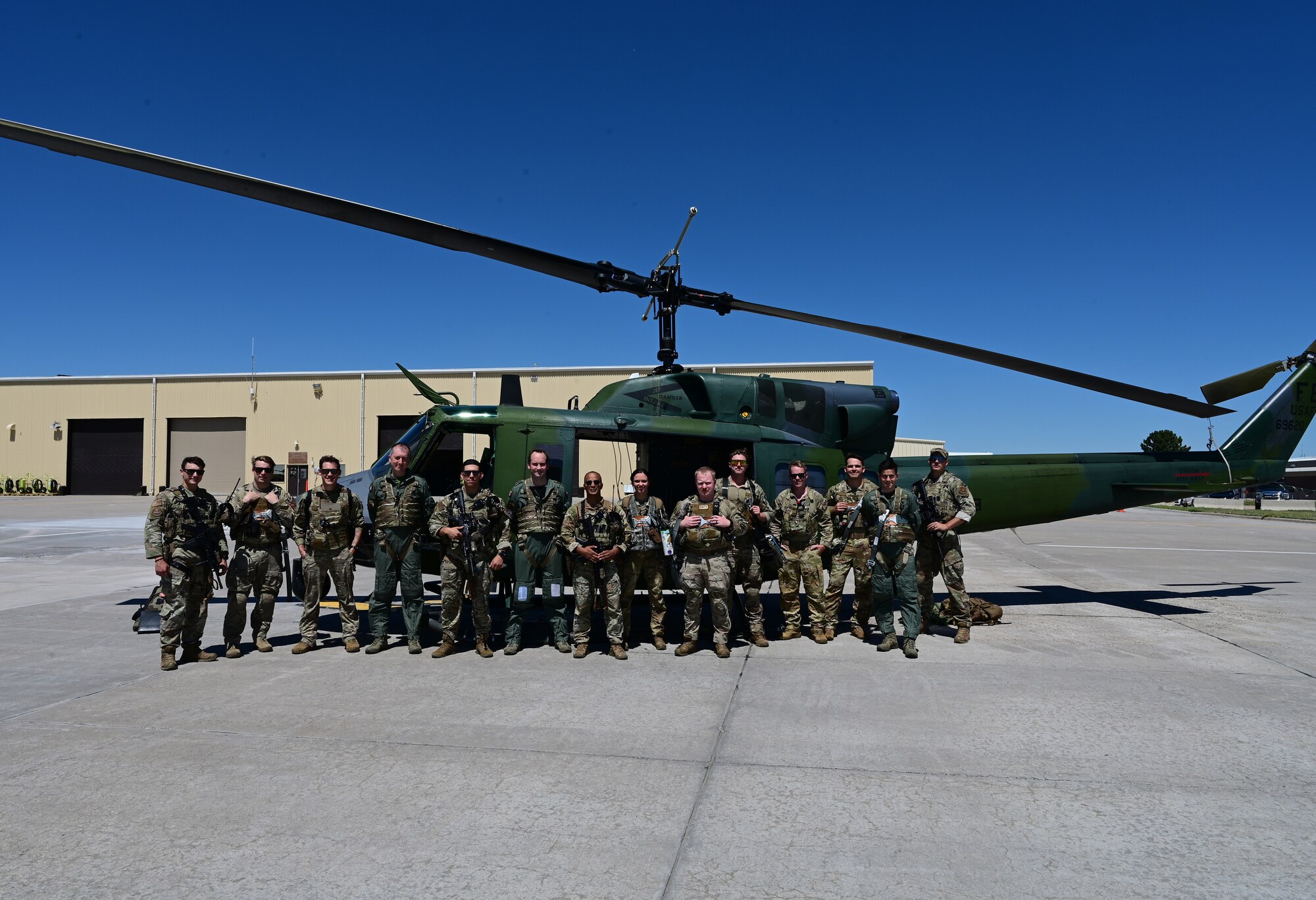 posing in front of a UH N1 Huey