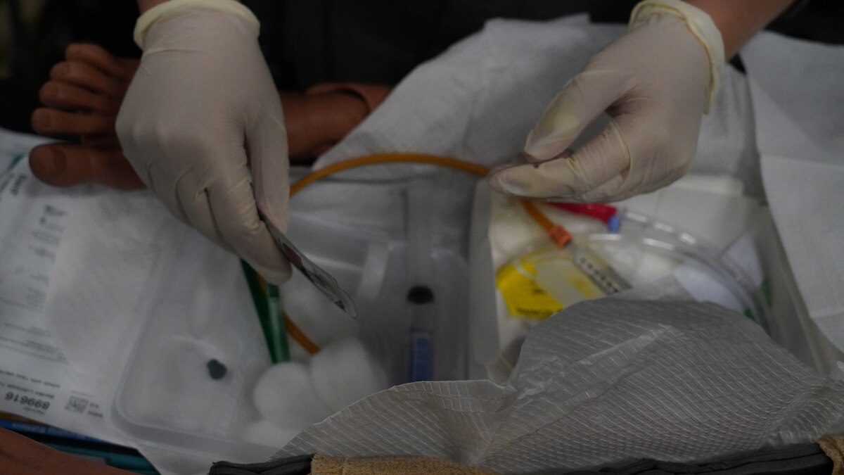 Hands wearing gloves, keeping an area sterile