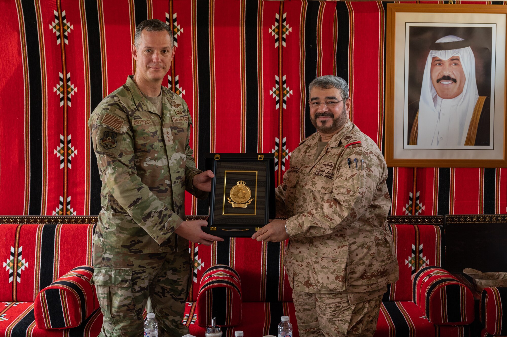 U.S. Air Force Lt. Gen. Alexus G. Grynkewich, left, Ninth Air Force (Air Forces Central) commander, receives a gift from Brig. Gen. Adel Al-Hafez, right, Kuwait Air Defense command chief, at the Kuwait Air Defense Headquarters, Aug. 17, 2022. During the visit, Grynkewich met with Kuwaiti military leaders to discuss the importance of resolute partnerships within the U.S. Central Command area of responsibility. (U.S. Air Force photo by Senior Airman Dominic Tyler)