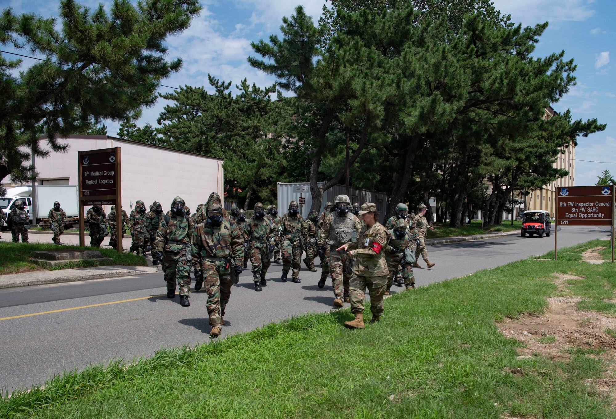 Airmen with the 8th Medical Group walk in mission oriented protective posture gear during a training event at Kunsan Air Base, Republic of Korea, Aug. 17, 2022. Training reinforces Airmen readiness, strengthens capabilities and ensures the Wolf Pack has the ability to defend the base, accept follow-on forces and take the fight north. (U.S. Air Force photo by Staff. Sgt Sadie Colbert)
