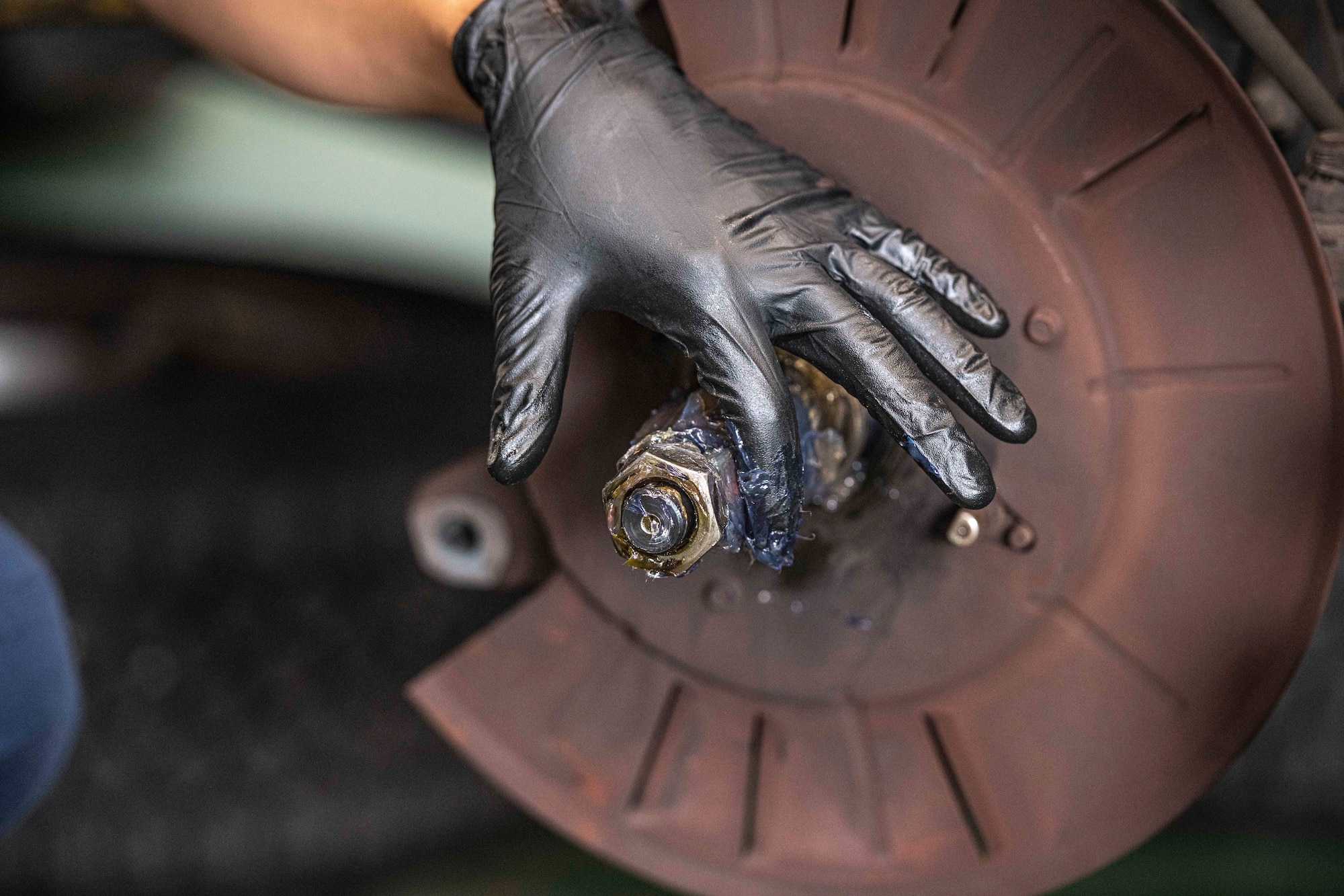 Airman 1st Class Deal Torre Joseph, 374th Logistics Readiness Squadron Vehicle Maintenance Flight apprentice, greases a bearing for brake assembly at Yokota Air Base, Japan, Aug. 17, 2022.